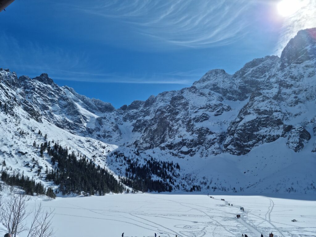 Klasyczny widok na zamarznięte Morskie Oko i Mięguszowieckie Szczyty w zimowej scenerii