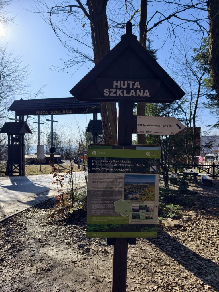 Drewniany drogowskaz w Świętokrzyskim Parku Narodowym kierujący na leśną ścieżkę edukacyjną w drodze na Święty Krzyż.