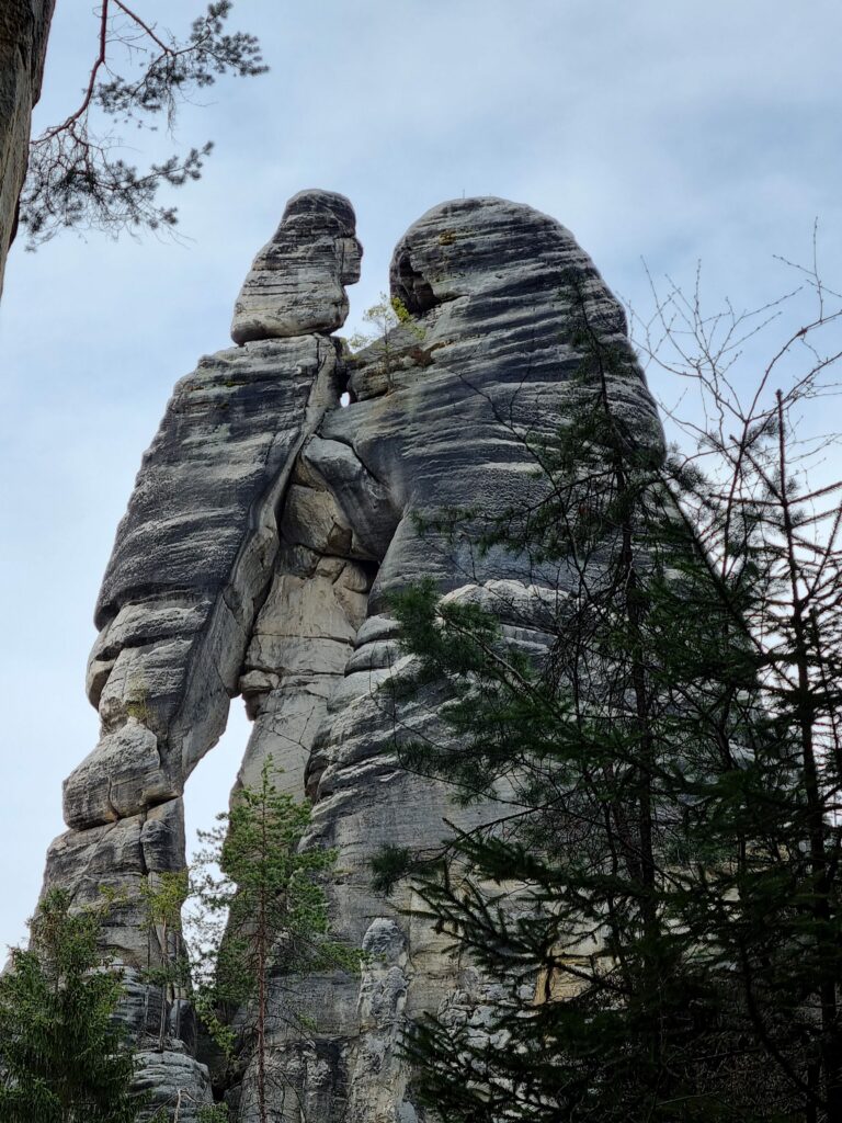 Prawie stumetrowa formacja skalna Kochankowie górująca nad wierzchołkami drzew w Skalnym Mieście w Czechach